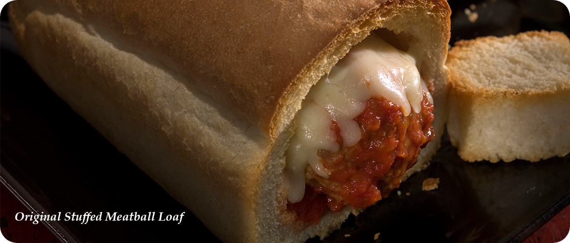 A loaf of bread hollowed out, filled with meatballs covered in marinara sauce and melted cheese, with a slice of bread beside it. Text reads "Original Stuffed Meatball Loaf".