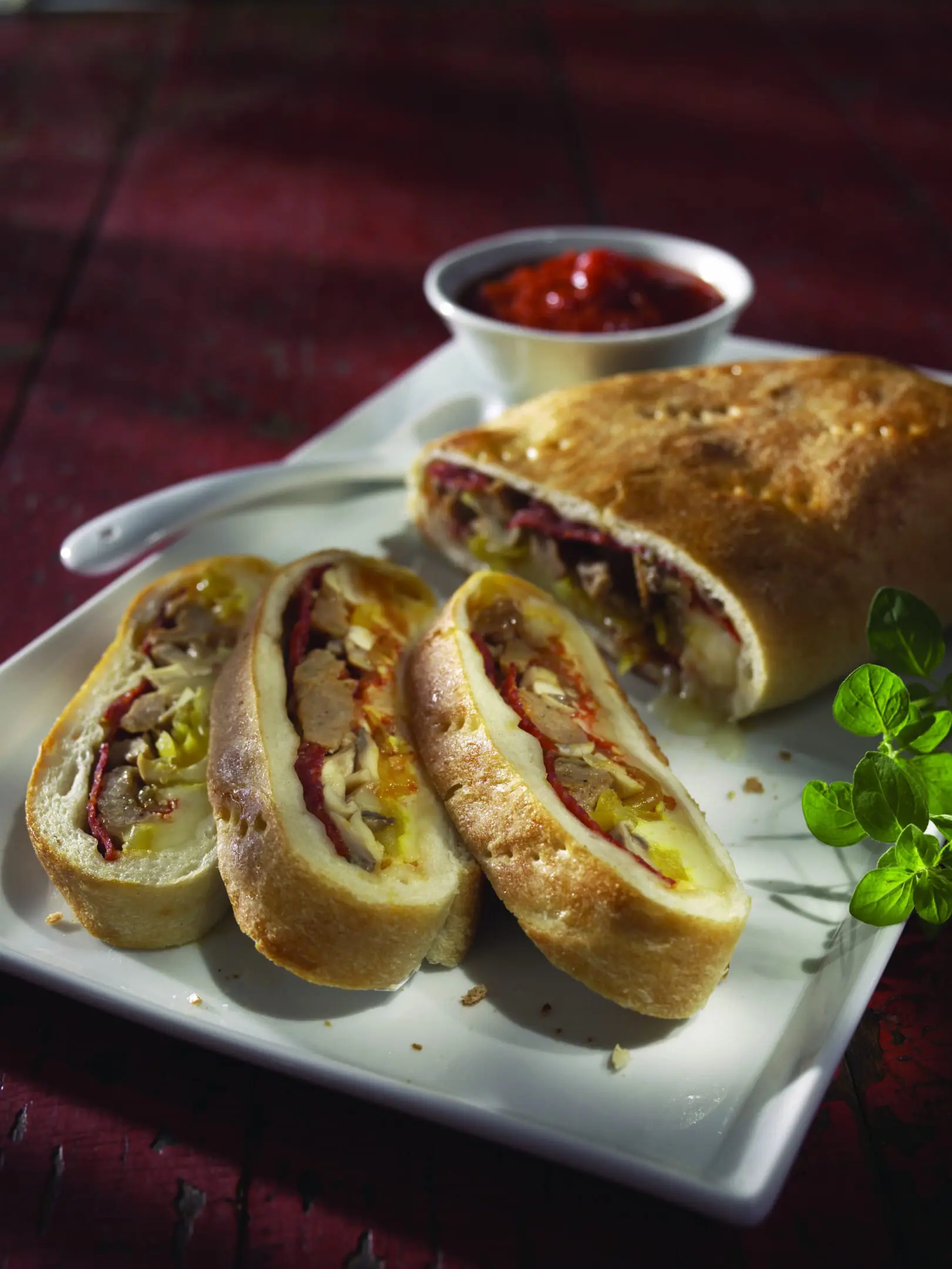 A plate with hot dogs and rolls on it