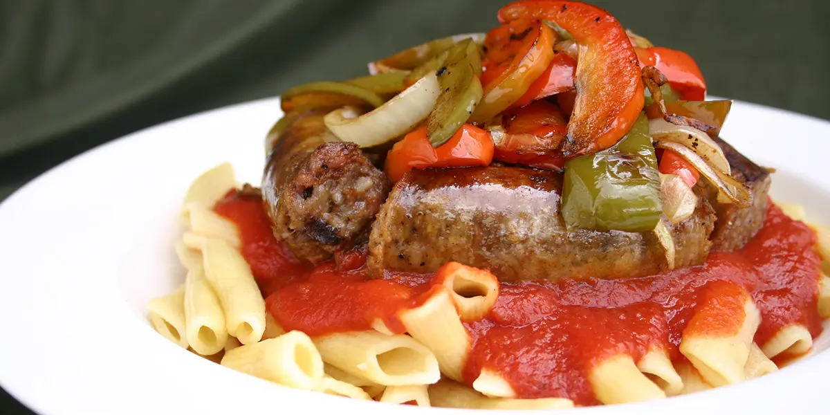 A plate of pasta with meat and vegetables.