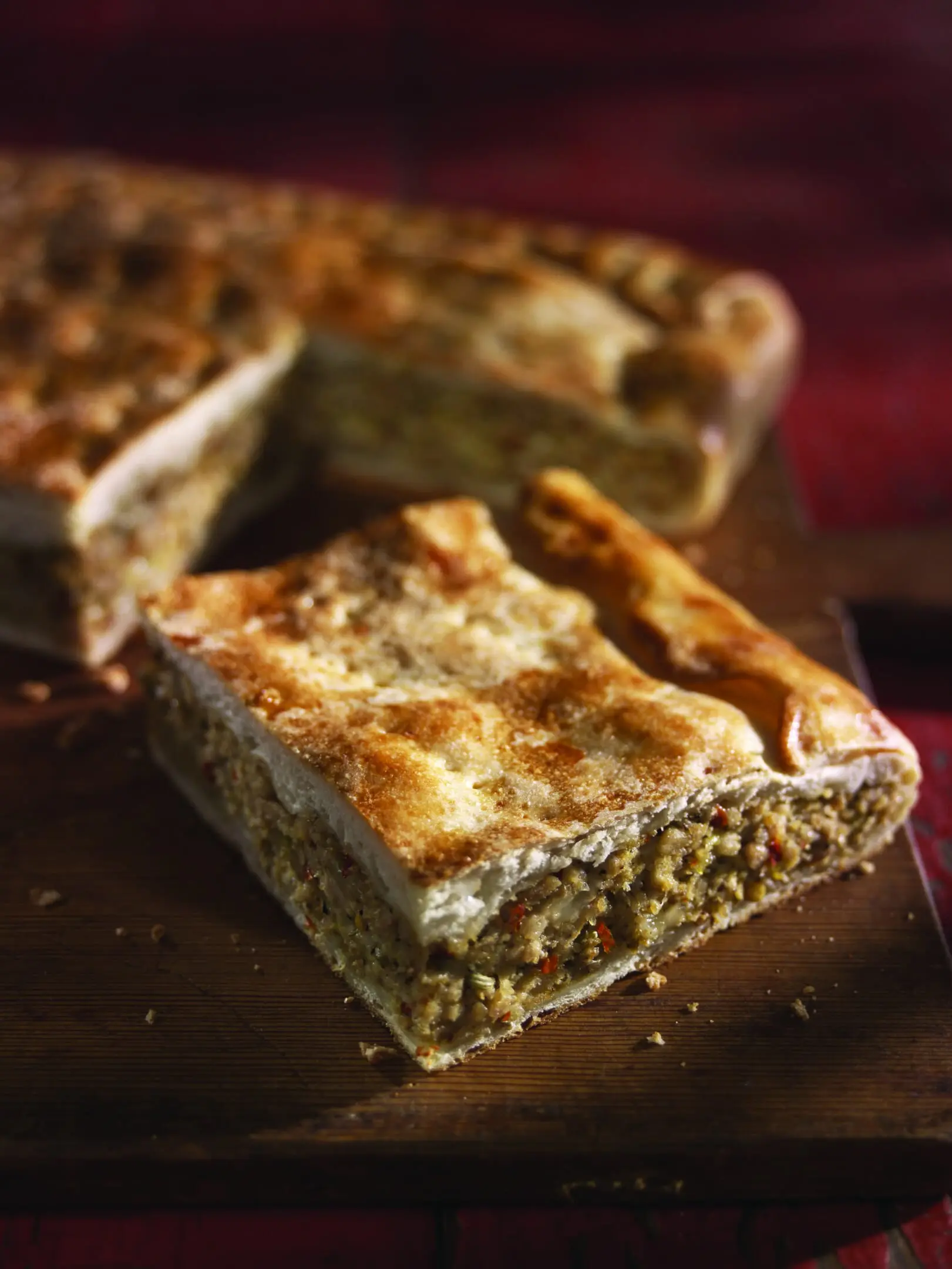 A piece of pie sitting on top of a wooden table.