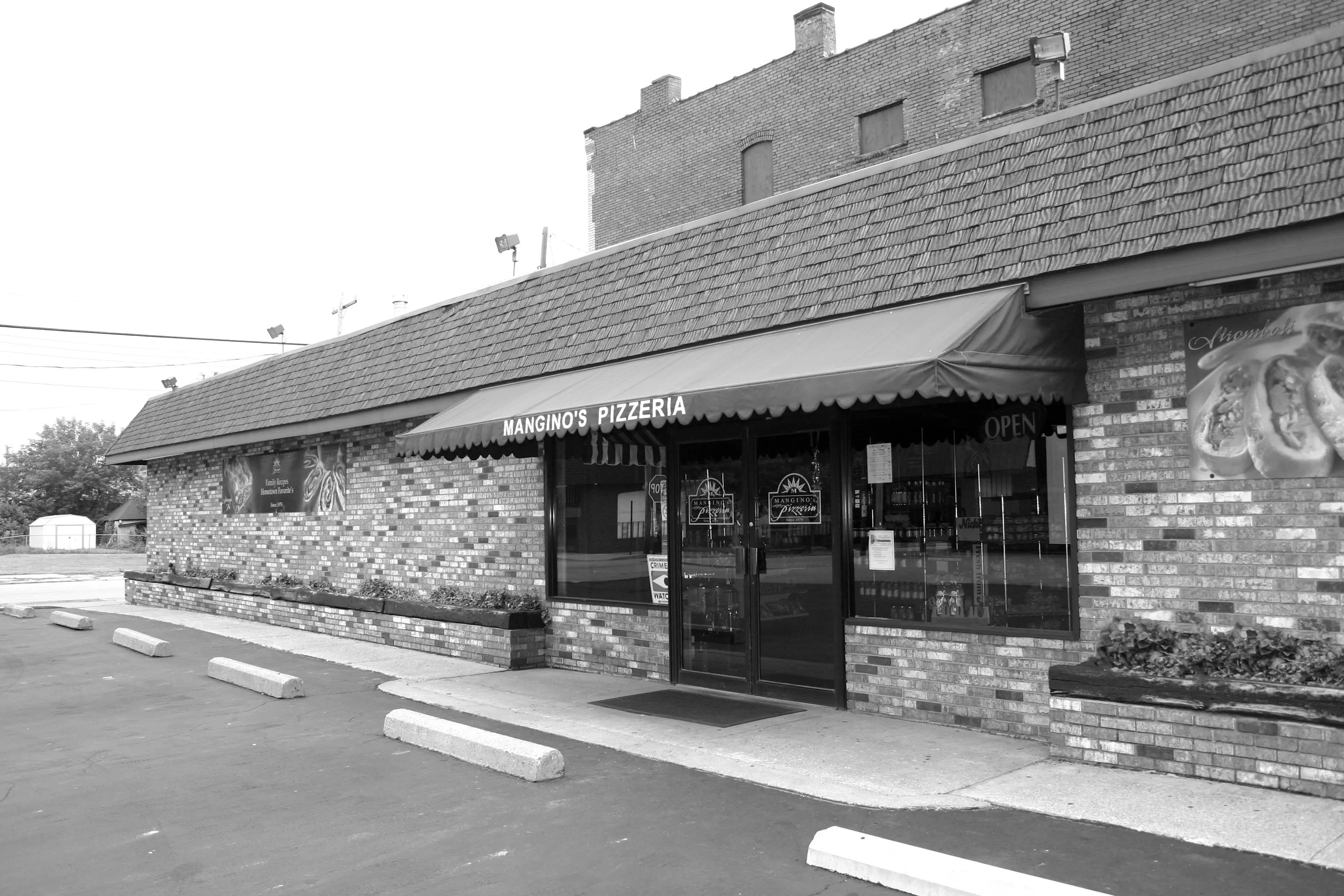 A black and white photo of the front entrance to a restaurant.