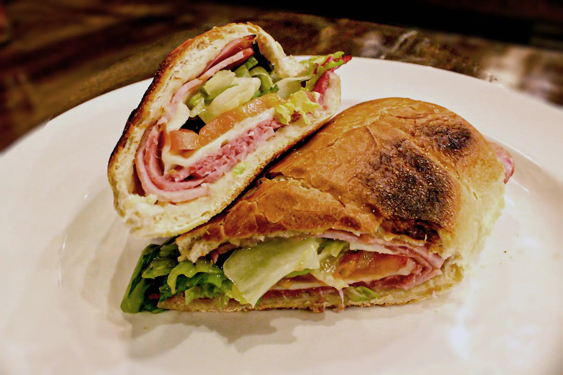 A sandwich cut in half on top of a plate.