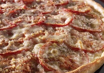 A pizza sitting on top of a pan covered in cheese.