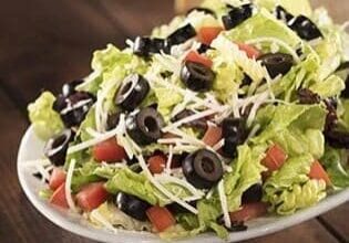 A plate of salad with lettuce, tomatoes and olives.