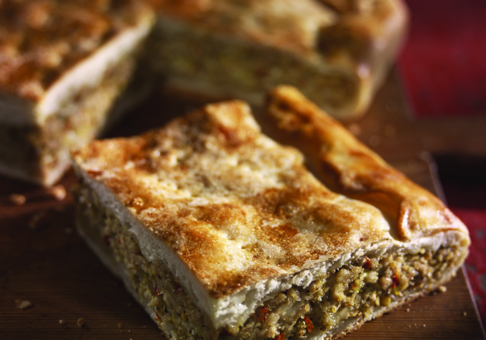 A piece of pie sitting on top of a wooden table.