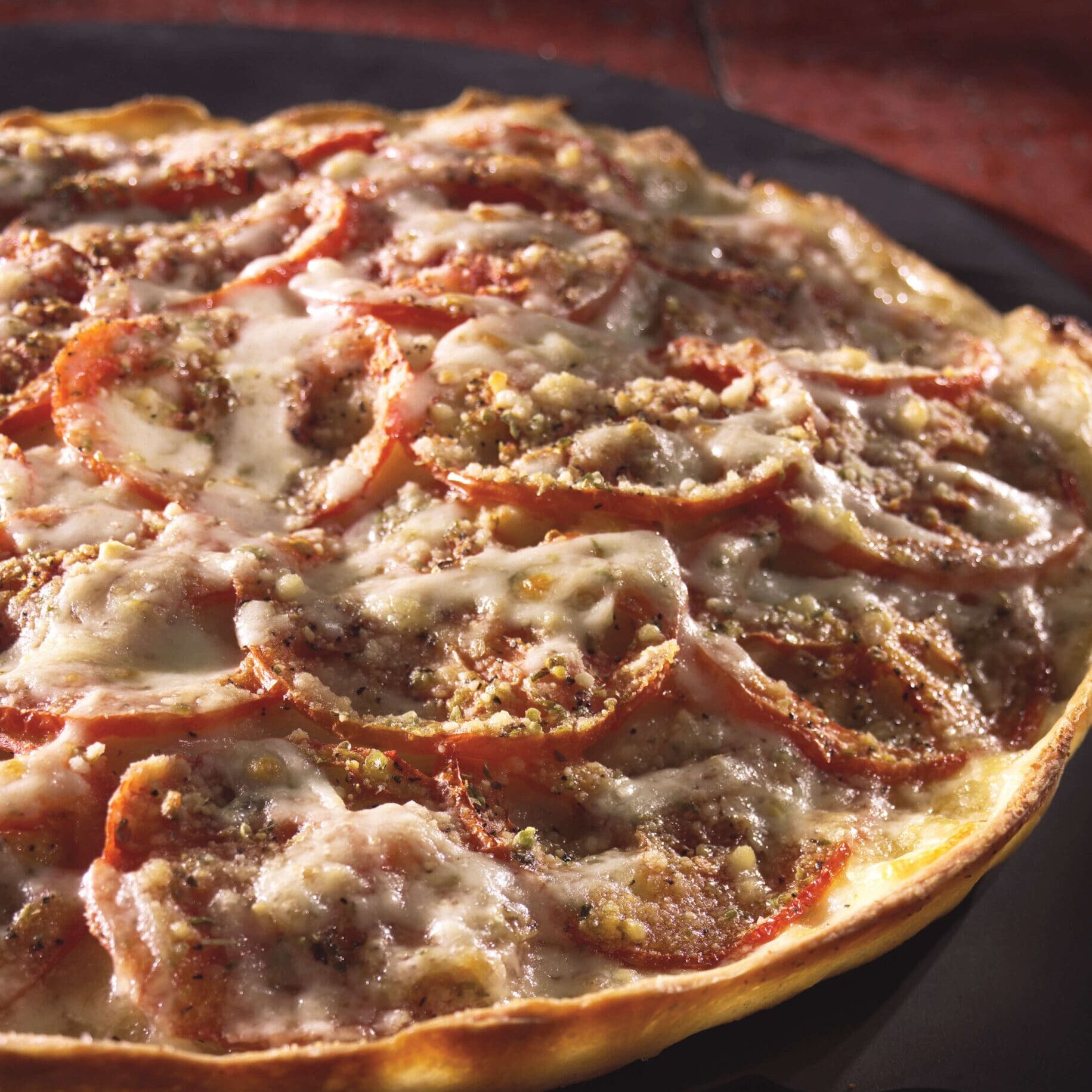 A pizza sitting on top of a pan covered in cheese.