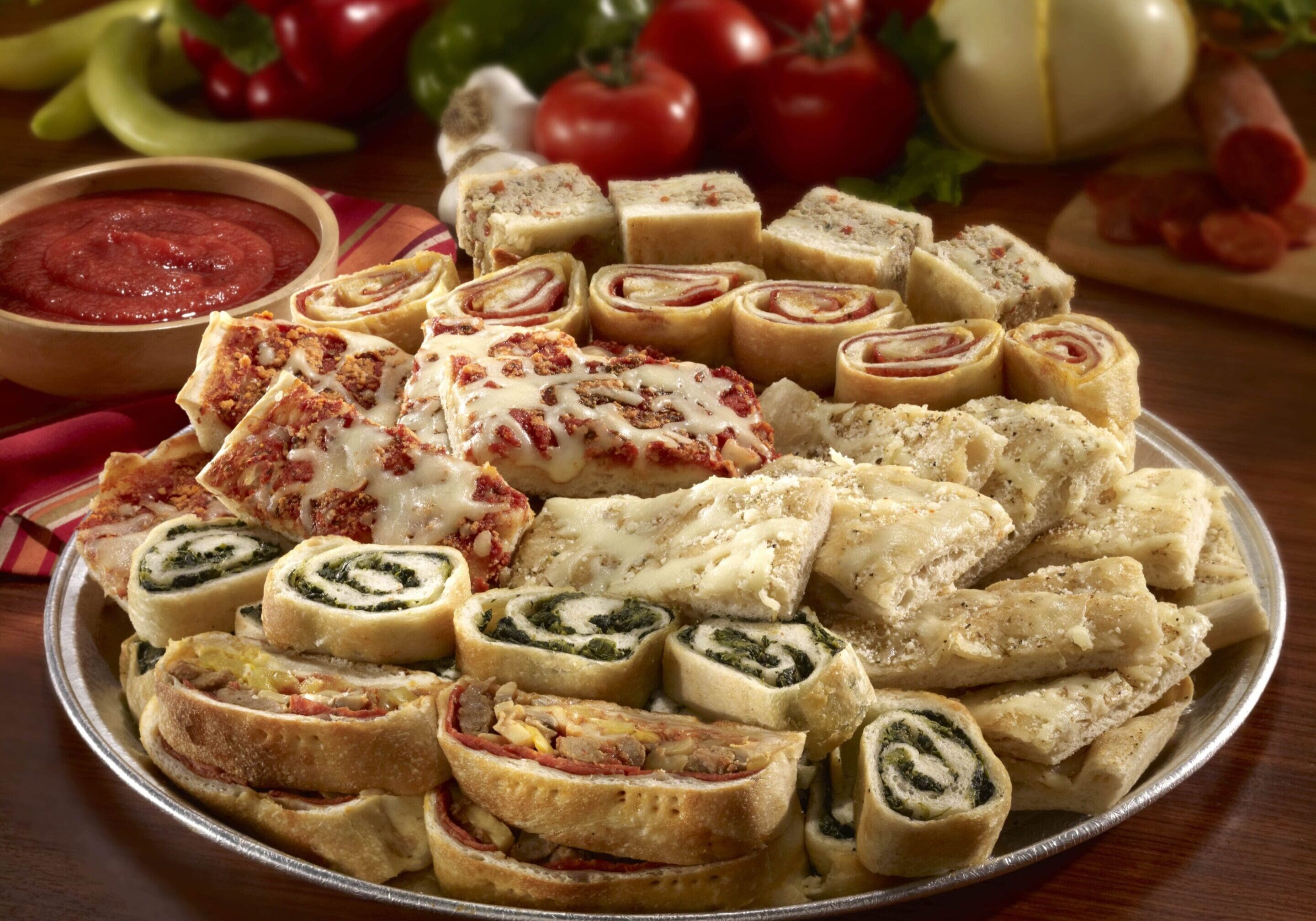 A platter of food with many different types of sandwiches.