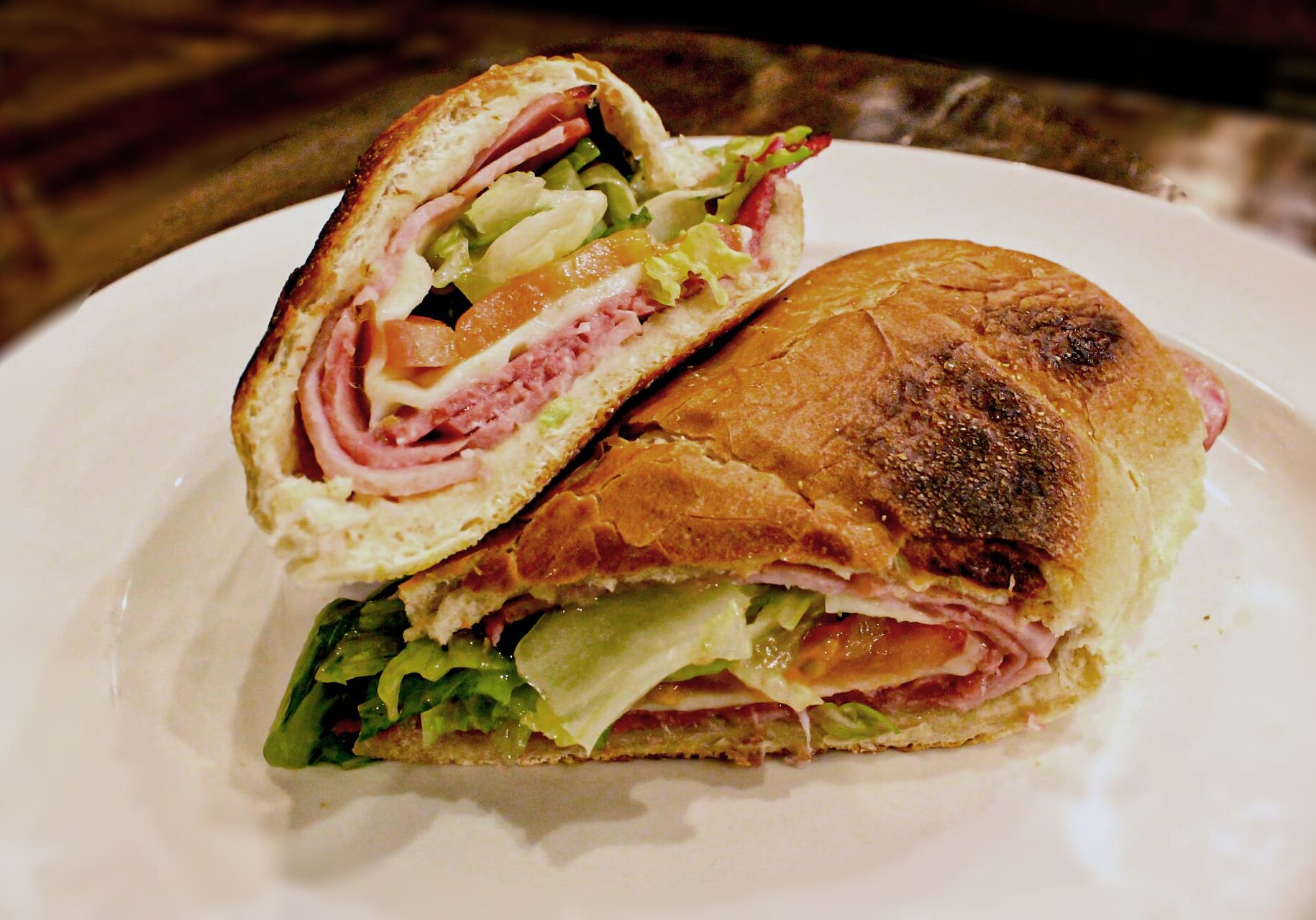 A sandwich cut in half on top of a plate.